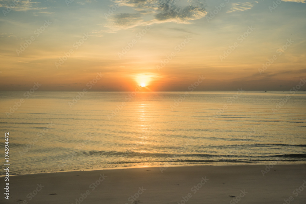 At a beach in Hua Hin city, Thailand. Sunrise over the sea, Calm ocean with Colorful dawn over the sea.