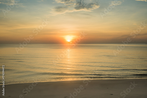 Fototapeta Naklejka Na Ścianę i Meble -  At a beach in Hua Hin city, Thailand. Sunrise over the sea, Calm ocean with Colorful dawn over the sea.