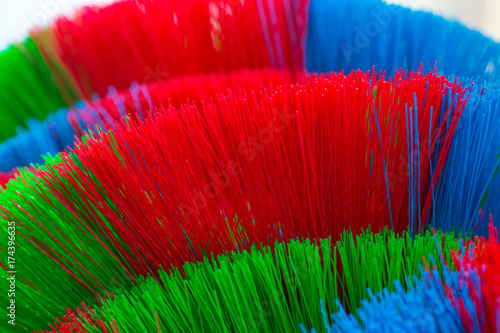 The colorful and patterns of plastic brooms.