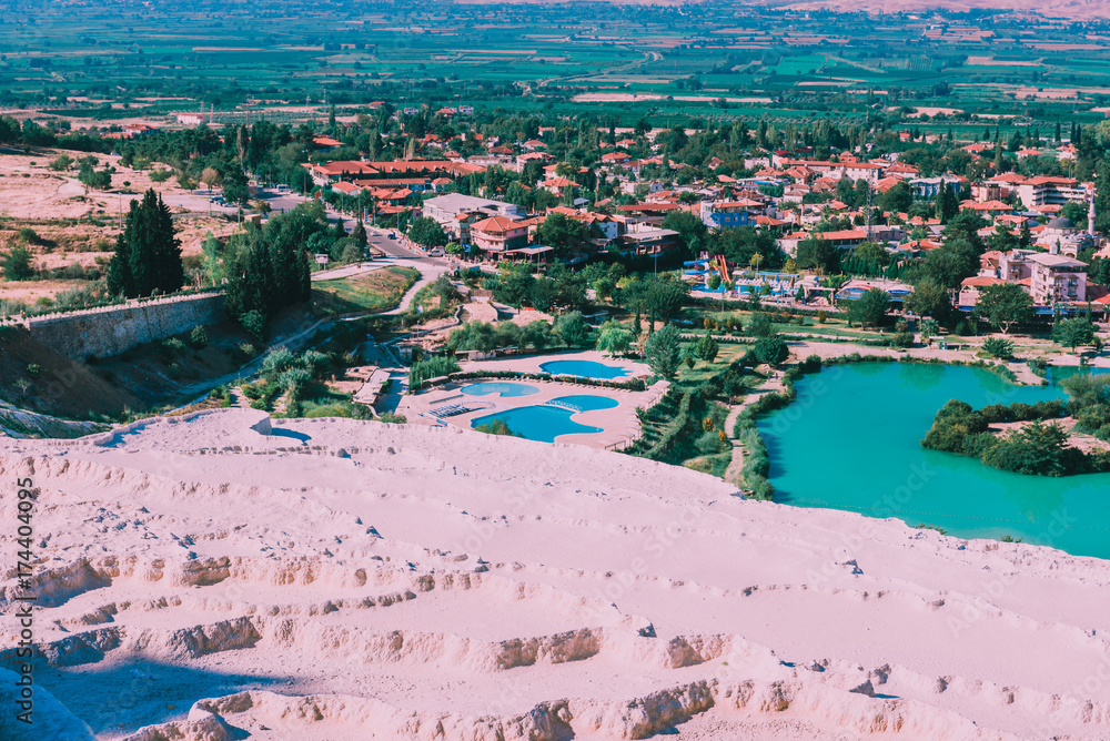 Turquoise color view of Pamukkale (Cotton Castle) is popular with Travertine pools and terraces  where people love to visit in Pamukkale, Turkey.