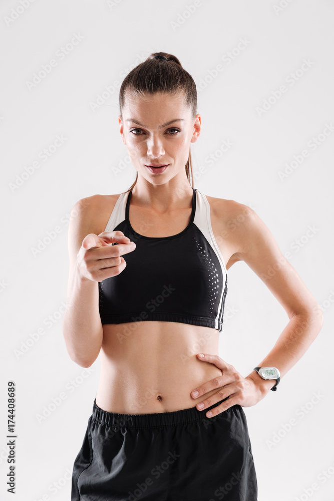 Portrait of a sportswoman standing and pointing finger at camera Portrait of a sportswoman standing and pointing finger at camera