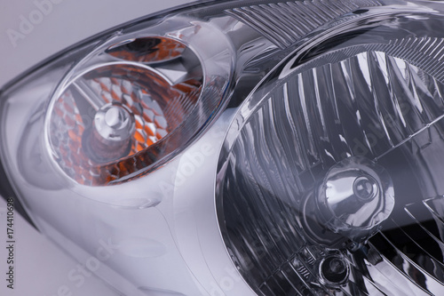 closeup of a car headlight on bright background. trimmed car headlight
