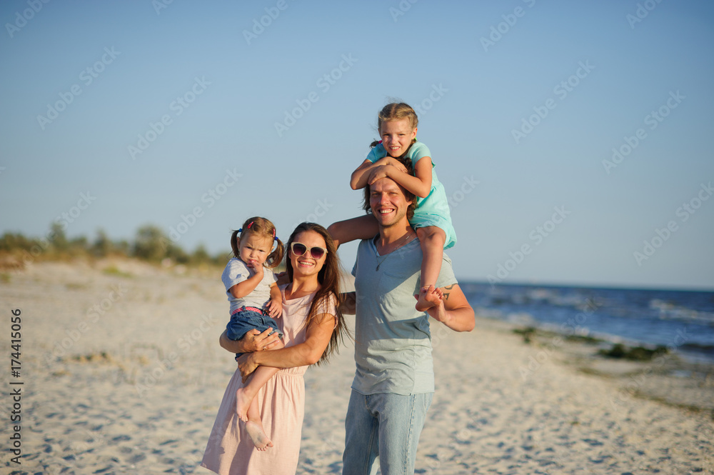 Young happy family on the beach.