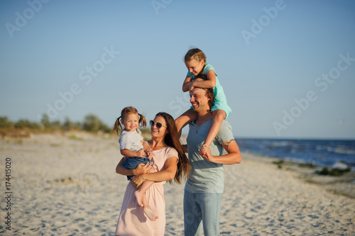 Young happy family on the beach.