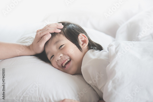 Asian child sleeping on white bed