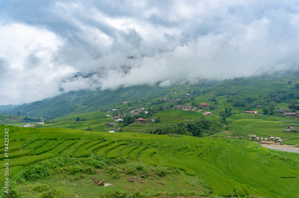 Rice terraces with Vietnamese village in the distance