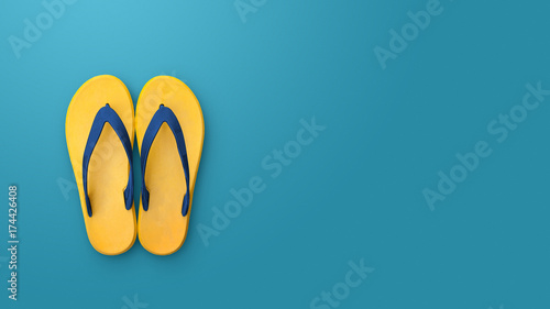 Flip flops isolated on blue background. Top view and copy space. Slippers yellow