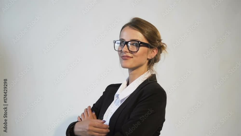 Ambitious young dark hair caucasian businesswoman, in a white blouse and a black jacket, is turning around in the white background, isolated, slow motion Ambitious young dark hair caucasian businesswoman, in a white blouse and a black jacket, is turning around in the white background, isolated, slow motion
