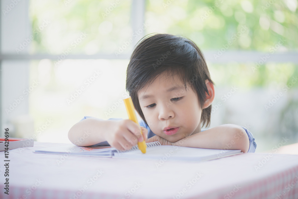 Asian child drawing picture with crayon Asian child drawing picture with crayon