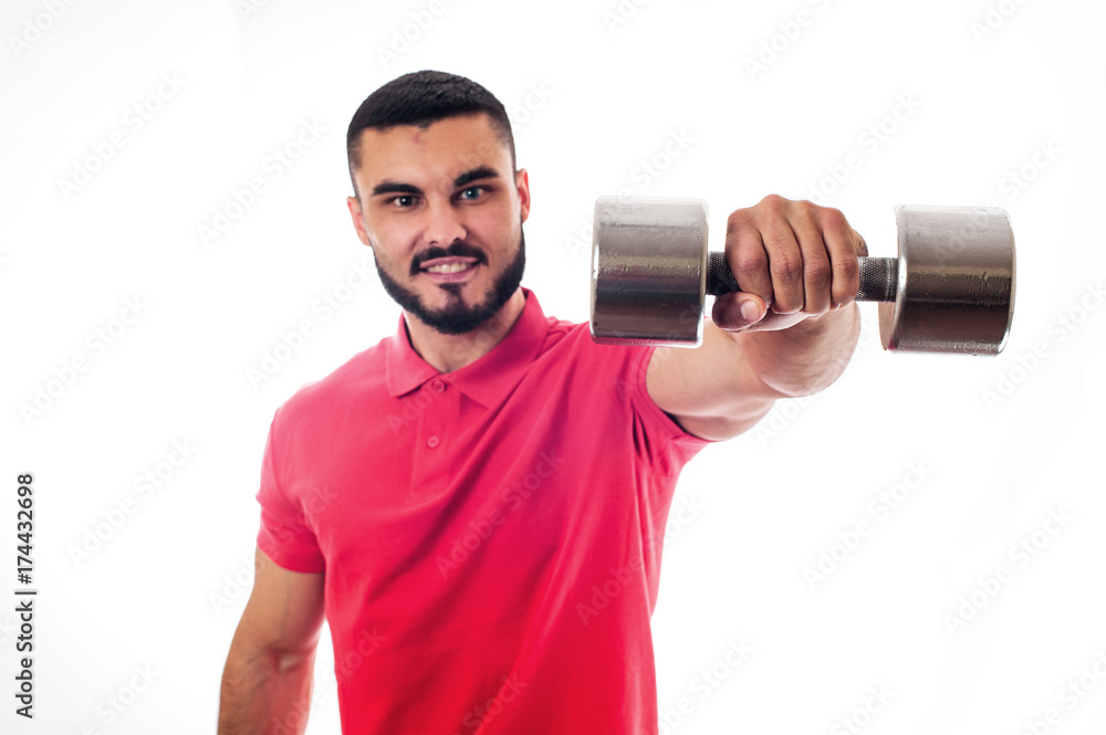 Smiling Athletic young man posing with weights Smiling Athletic young man posing with weights