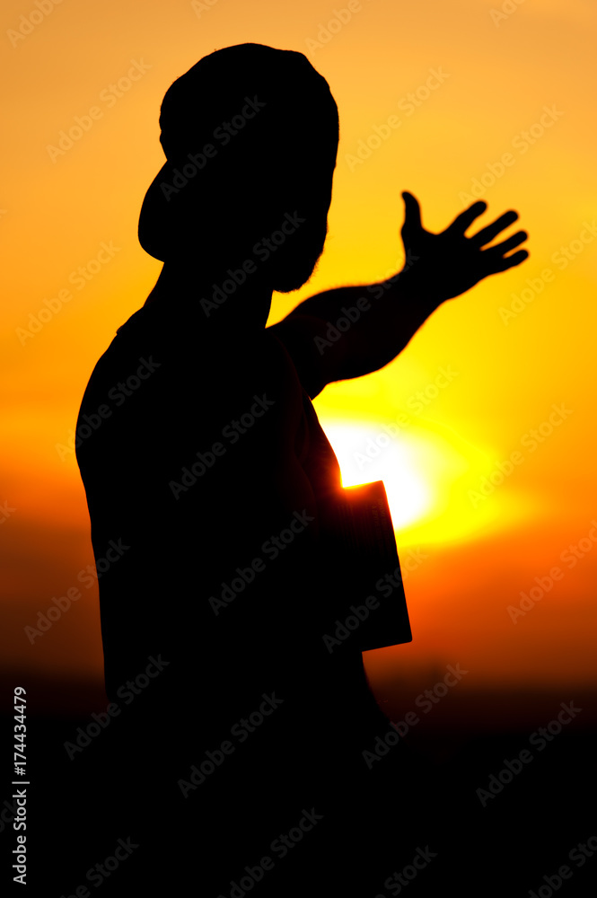 Silhouette of relaxed man enjoying sunset time