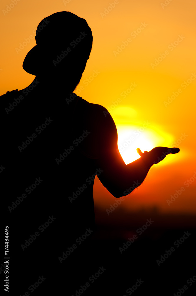 Silhouette of relaxed man enjoying sunset time