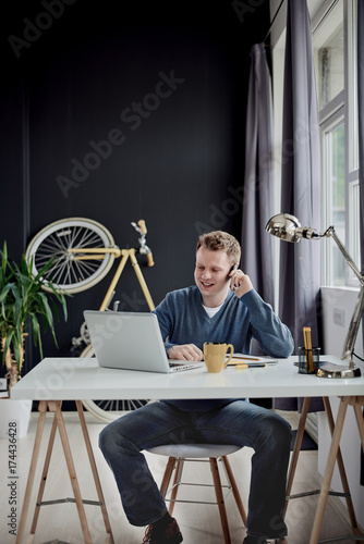 Businessman using smart phone for business talk and sitting at home office