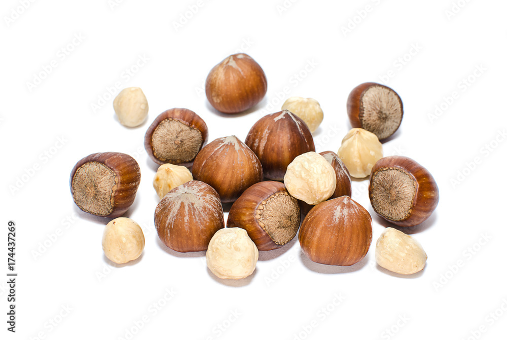 Whole and peeled hazelnuts isolated on white Whole and peeled hazelnuts isolated on white