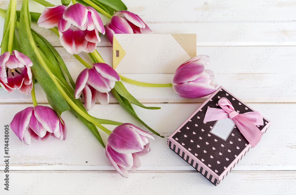 tulips flower on wooden background with empty card and gift box tulips flower on wooden background with empty card and gift box