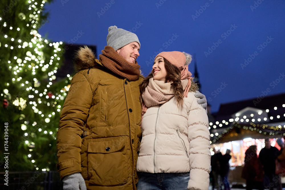 happy couple talking at christmas tree happy couple talking at christmas tree