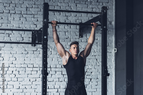 man doing pull ups photo