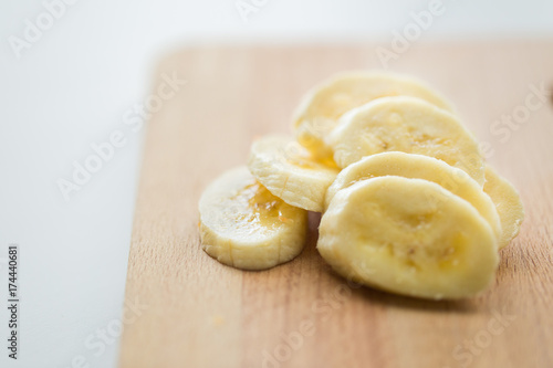 close up of banana on wooden cutting board