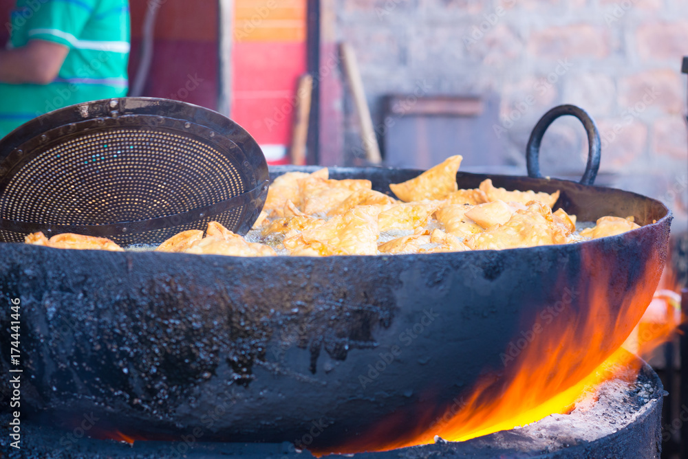 Cooking and deep frying in fatiscent big pan or wok, street food