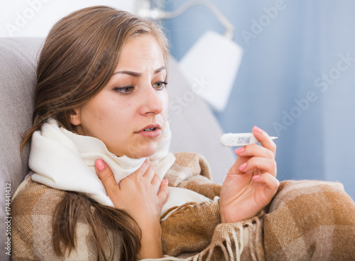 Ill girl measuring temperature photo