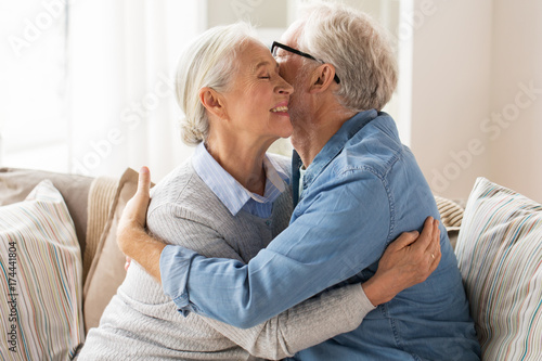 happy senior couple hugging at home