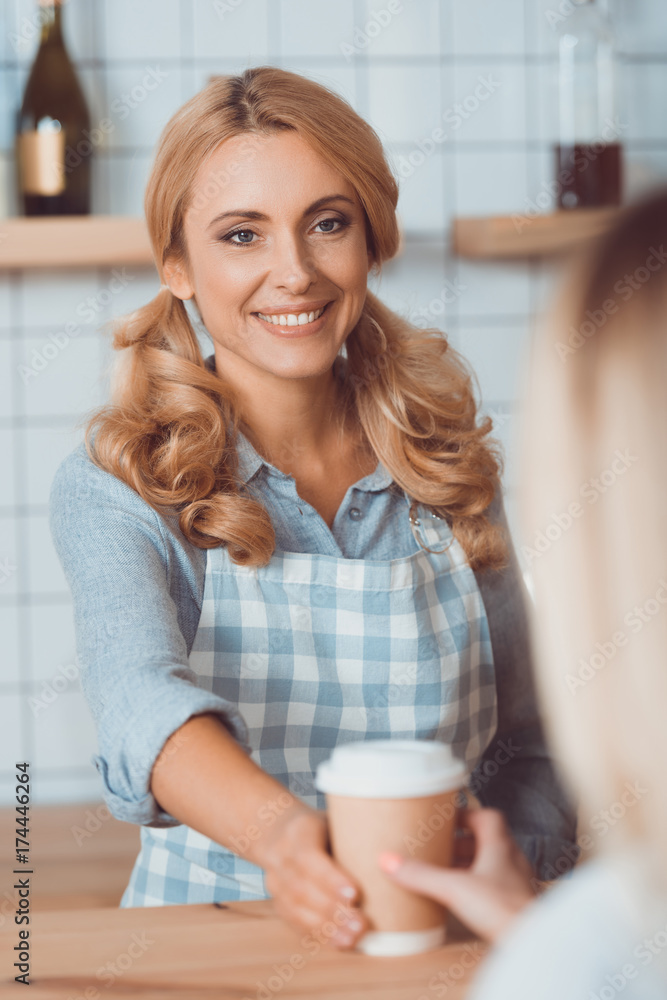 waitress holding disposable coffee cup waitress holding disposable coffee cup