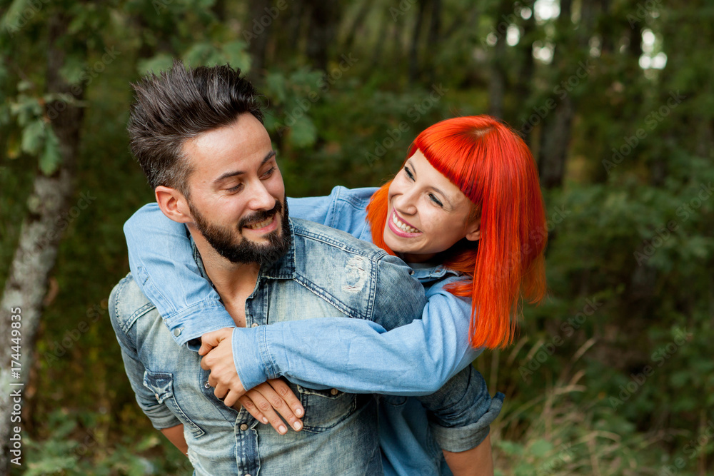 Handsome guy giving piggyback ride to girlfriend Handsome guy giving piggyback ride to girlfriend
