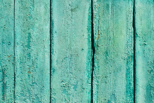 Ancient vintage wooden texture. A painted green, blue wall. Cracked paint. Grunge colored background for design. Stock Photo
