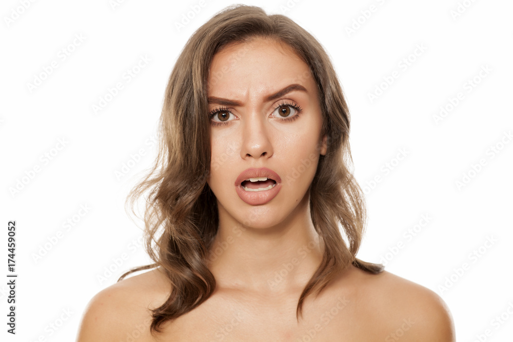 Portrait of beautiful young surprised woman on white background Portrait of beautiful young surprised woman on white background