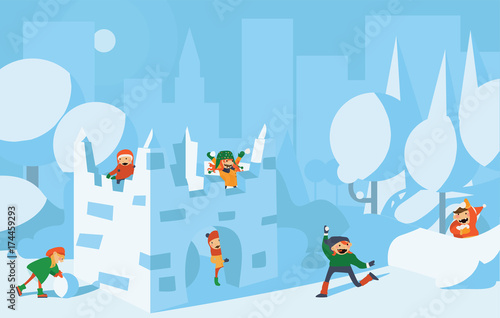 Happy cute kids playing with snow fort castle.