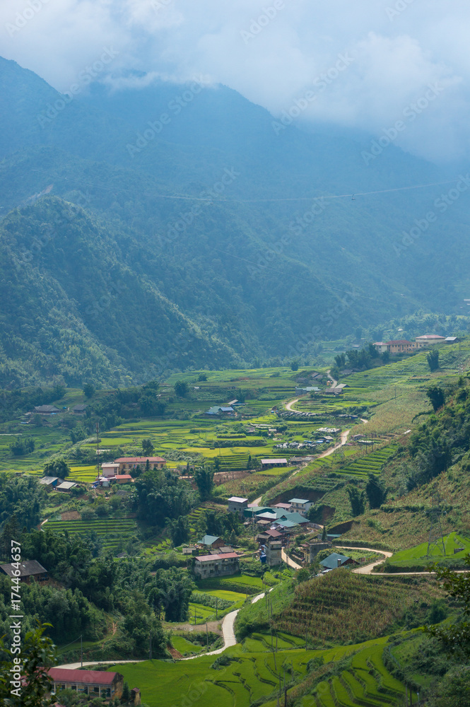 Spectacular view on mountain valley village with rice terraces