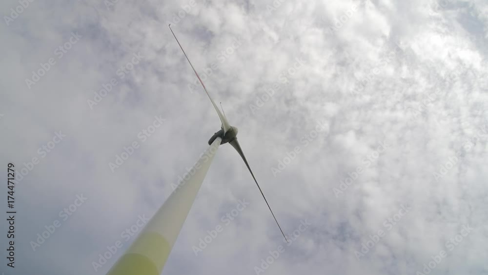Wind turbine over stormy cloudy sky using renewable energy to generate electrical power. Renewable energy is most environmental way of power generation. Wind turbine over stormy cloudy sky using renewable energy to generate electrical power. Renewable energy is most environmental way of power generation.