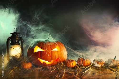 Halloween theme with pumpkins under spider web
