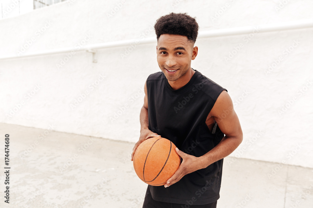 Young african man play basketball outdoors. Young african man play basketball outdoors.