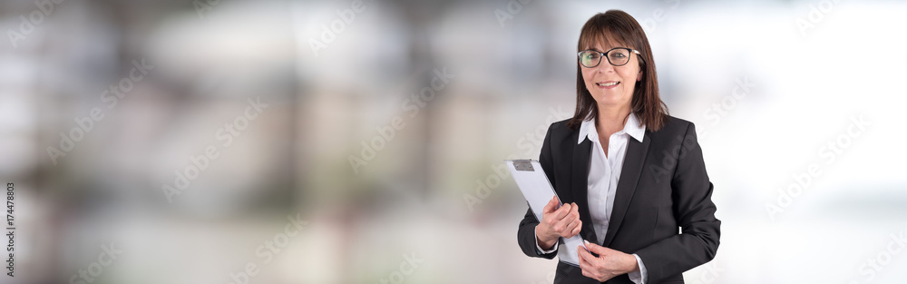 Portrait of mature businesswoman holding a clipboard Portrait of mature businesswoman holding a clipboard