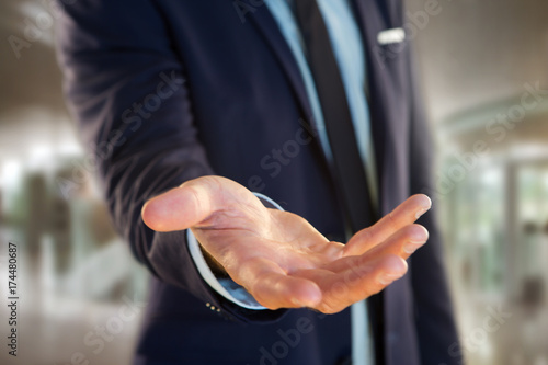 Businessman giving an empty hand at the office