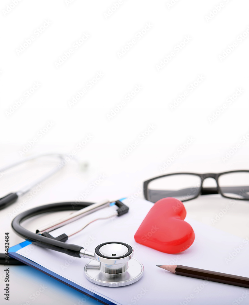 Doctor’s desk. Stethoscope and red heard on the table Doctor’s desk. Stethoscope and red heard on the table