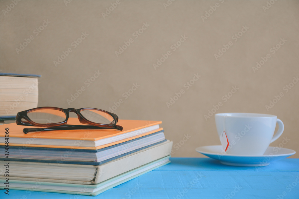 Book glasses and tea on the desk with study and education concept Book glasses and tea on the desk with study and education concept