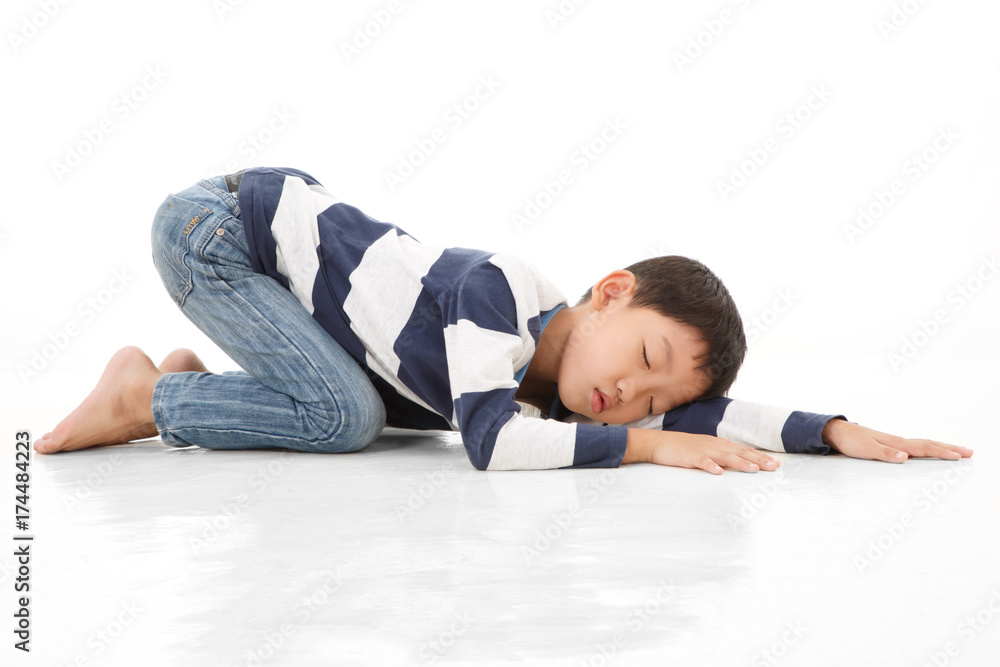 Asian cute boy sleeping while lay down on floor. White background. Asian cute boy sleeping while lay down on floor. White background.