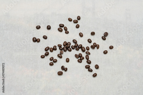 Coffee beans on sackcloth texture background.