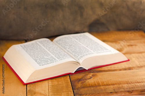 Vintage book open on old wooden table.
