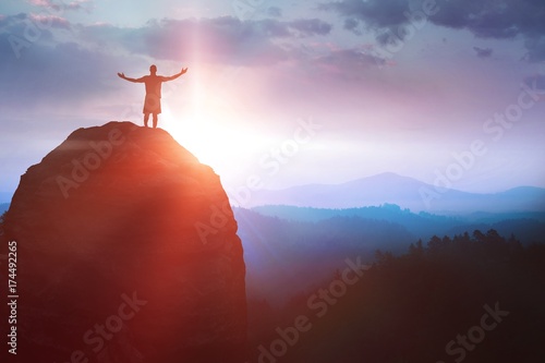 Composite image of shadow of men standing and raising arms photo