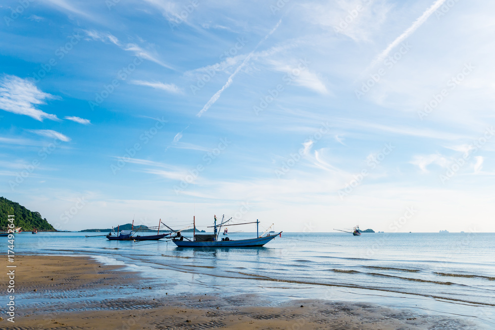 Traditional fishing boat on the beach with blue sky