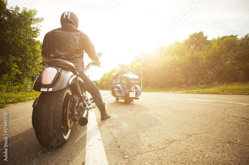 Vászonkép two bikers riding unknown motorbike with blur movement, speed concept