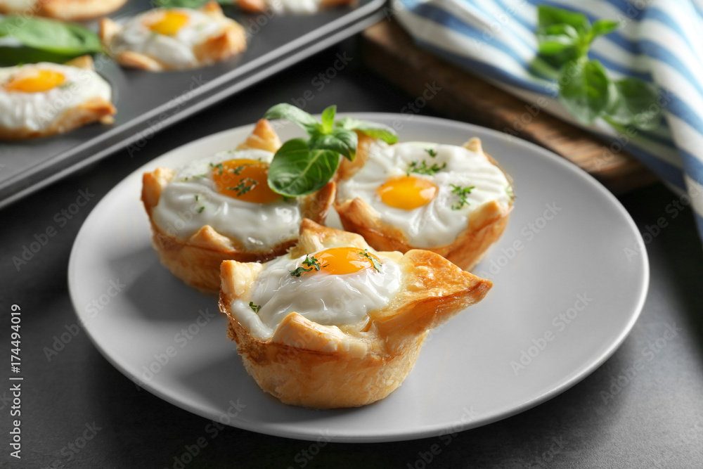 Tasty baked eggs in dough on plate Tasty baked eggs in dough on plate
