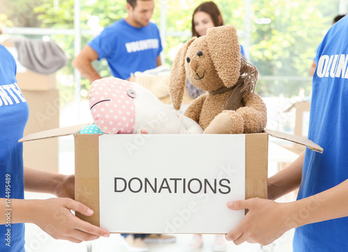 Two volunteers holding box ...