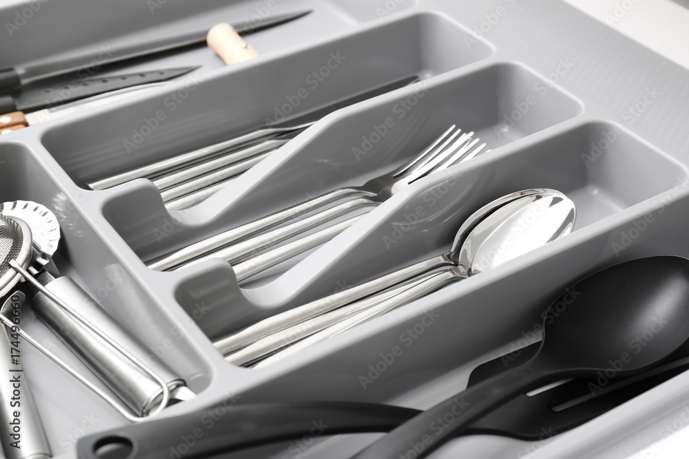 Kitchen utensils in drawer, closeup Kitchen utensils in drawer, closeup