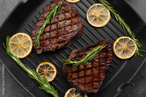 Wallpaper Mural Grill pan with delicious steaks on kitchen table Torontodigital.ca