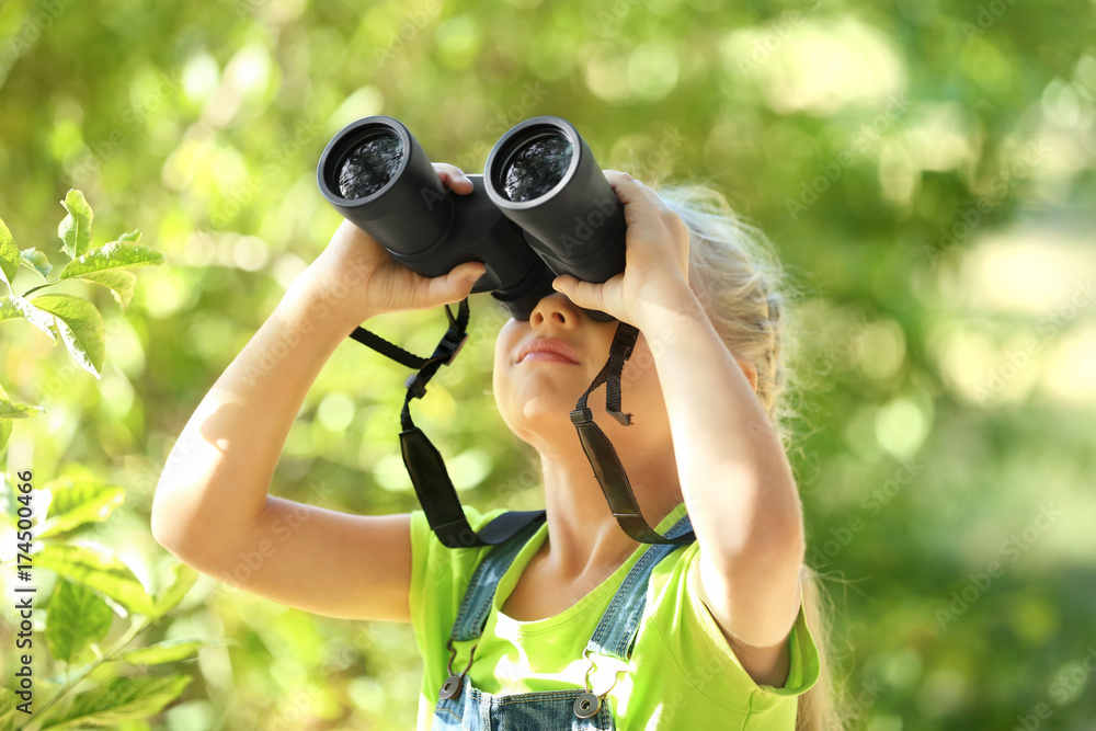 Cute girl looking through binoculars outdoors Cute girl looking through binoculars outdoors