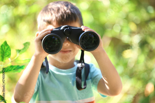 Cute boy looking through bi...